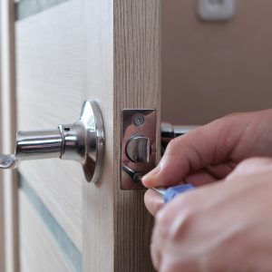 Man,Repairs,Lock,Interior,Door,With,Screwdriver