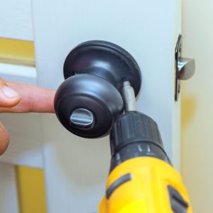 Worker,Installs,Lock,In,New,Interior,Door,With,Using,Screwdriver