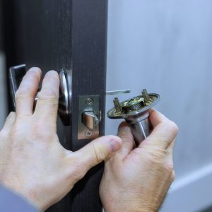 Mechanic,Installs,Lock,Handles,On,Room,Doors,At,New,House