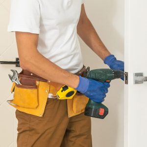 Handyman,Fitting,A,New,Door,Using,A,Screwdriver,At,Home